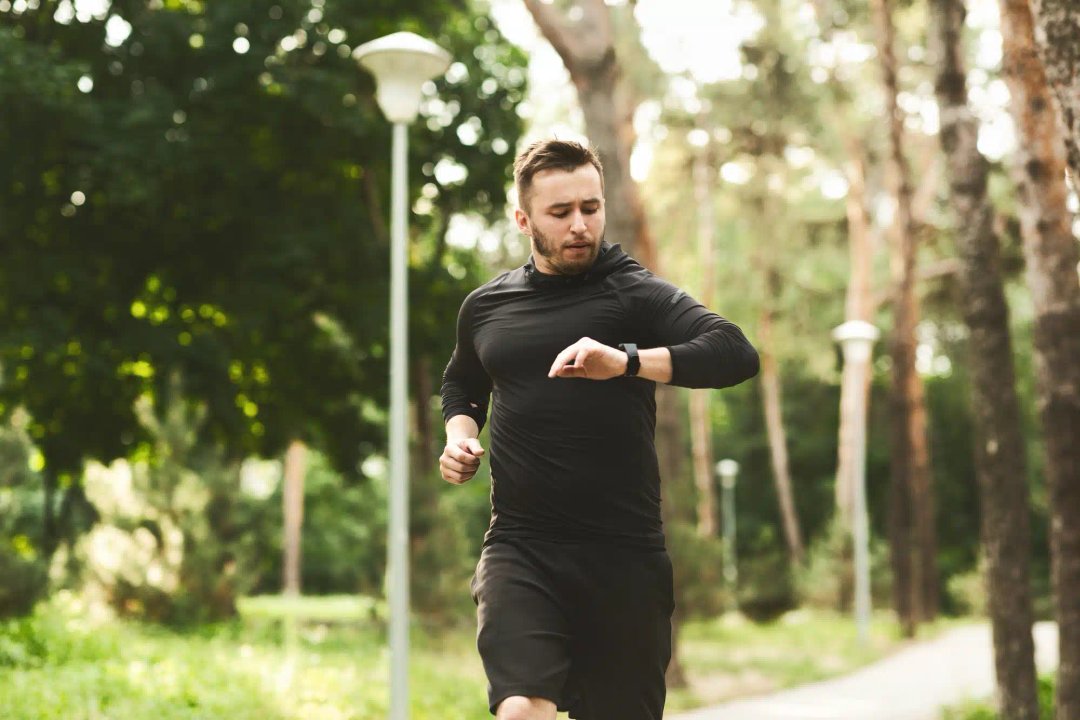 Ceas smartwatch barbati si Un bărbat care face jogging în parc cu ceasul lui. ceasuri smartwatch barbati